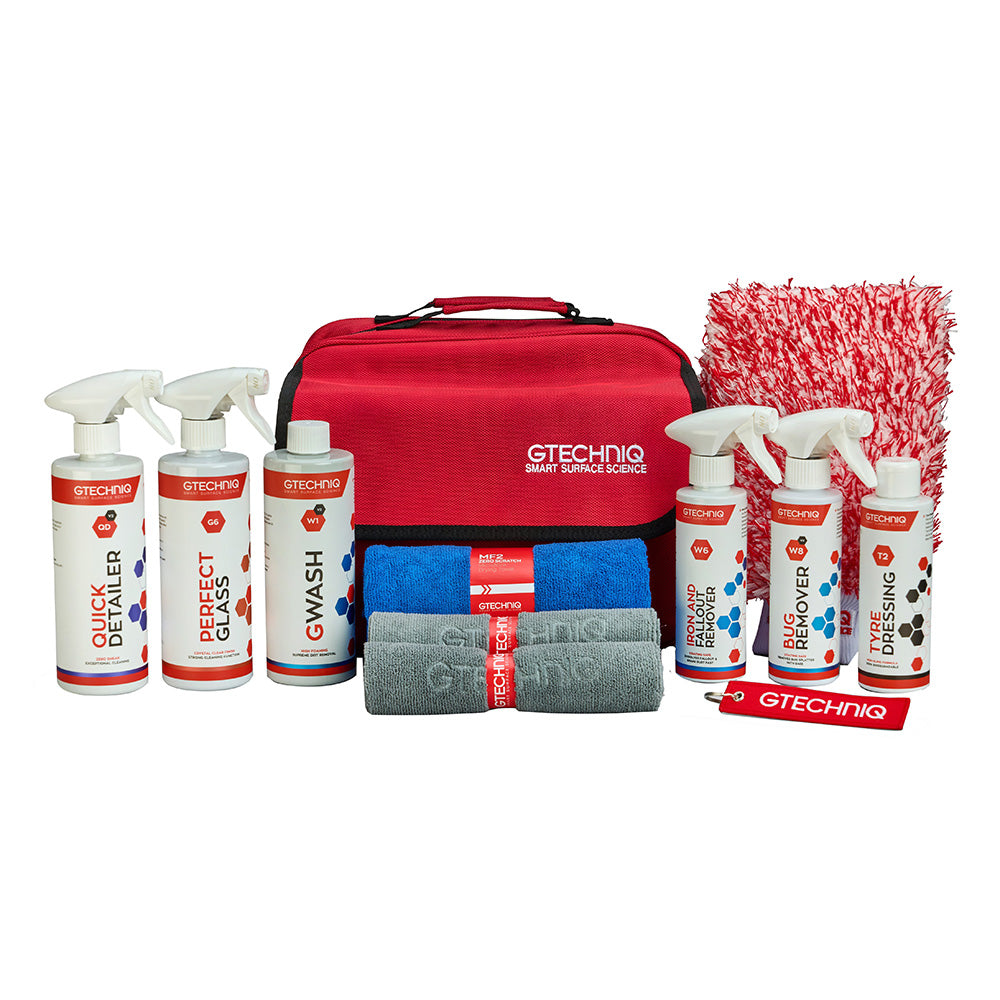 A GTECHINO car detailing kit arranged on a white background, including spray mists, bottles, towels, cloths, and a red carrying case with a red-and-white microfiber cloth.