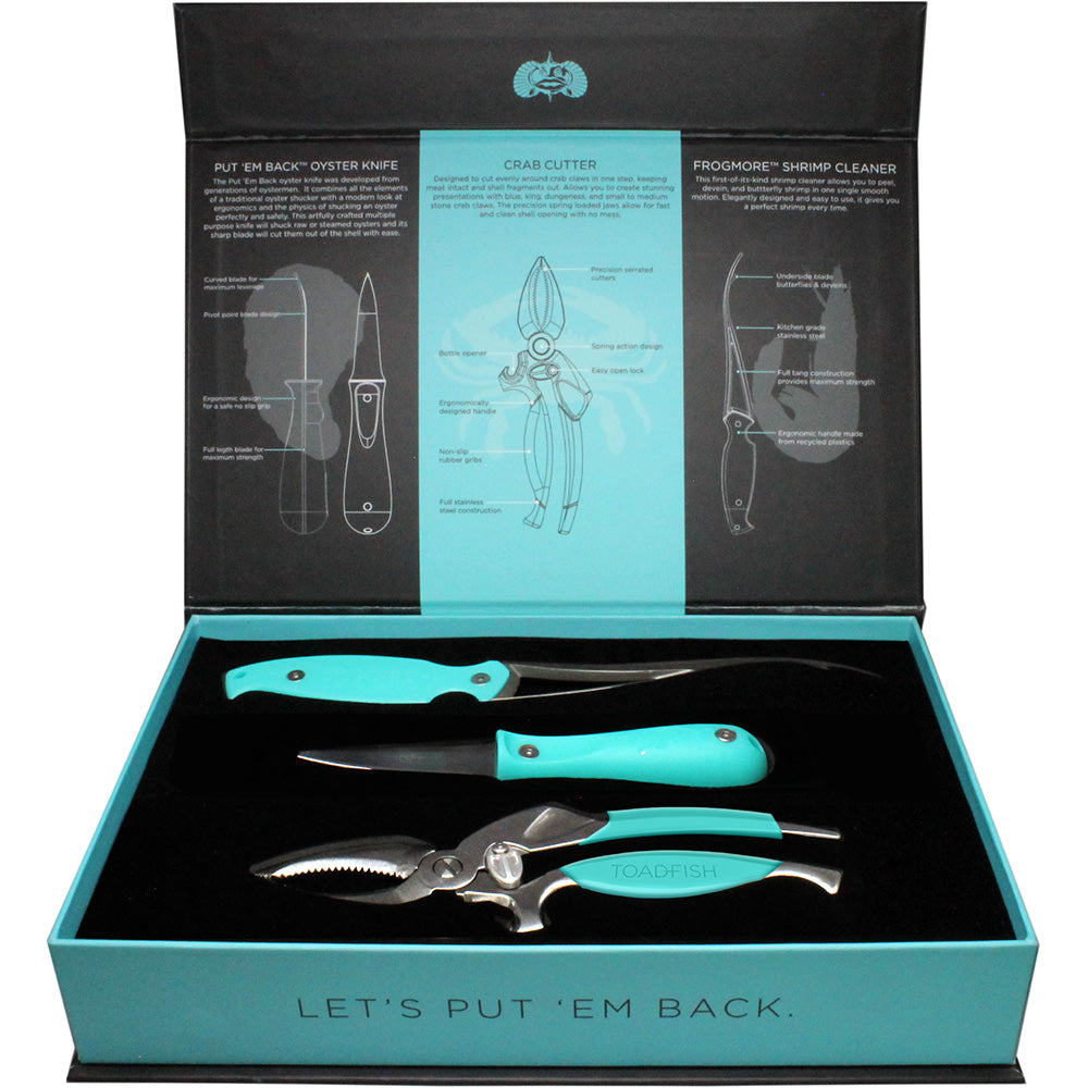 A set of seafood preparation tools including an oyster knife, shrimp cleaner, and crab cutter with blue handles, displayed in an open box with labels and illustrations for each tool.